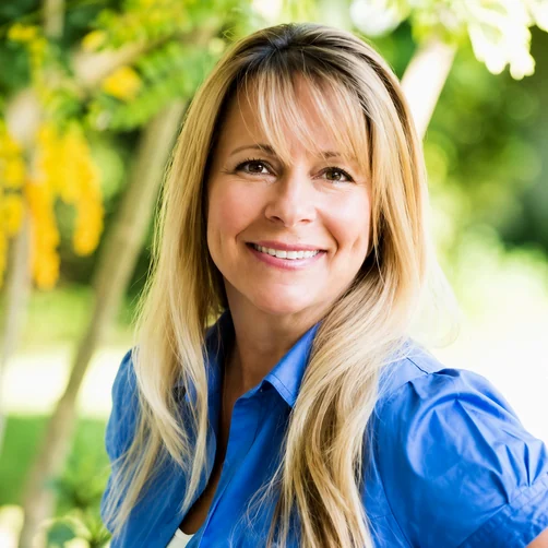 Susanne Maastricht, owner of Amaya Insurance, smiling outdoors